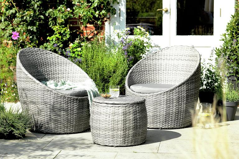 Two grey wicker garden chairs and coffee table.