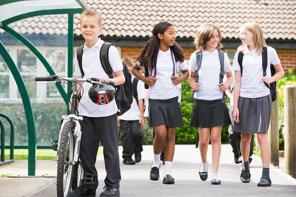 Group of uniformed children leaving school.