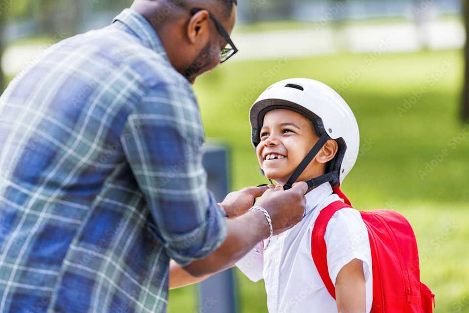 A boy wearing a grey helmet.