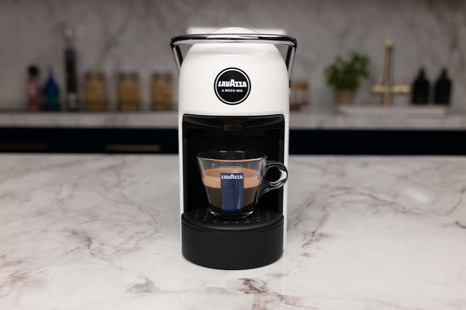 The Lavazza A Modo Mio Jolie coffee machine pouring a cup of espresso.
