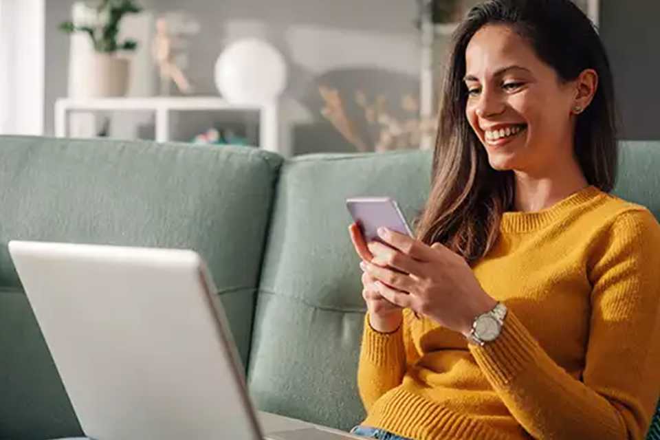Woman paying for argos order on phone.