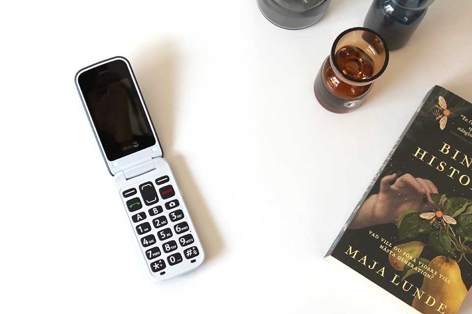 Doro 2424 placed on a tabletop with other things.