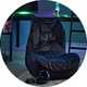 Gaming chair in gaming room with gaming set up.
