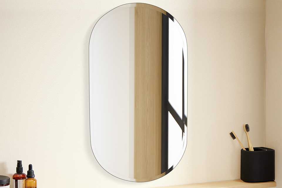 An Argos Home oval bathroom mirror in a bathroom.