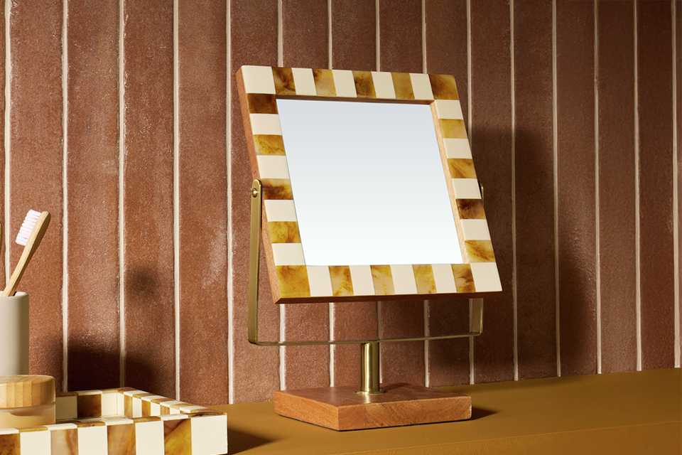 A Habitat chequered natural wood bathroom mirror in a bathroom.