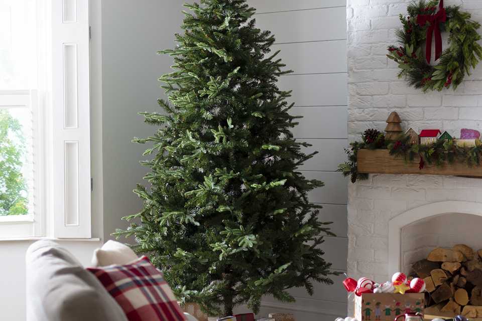 A Habitat 8ft unlit natural look tree in a cosy living room.