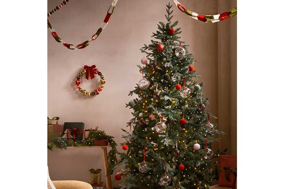 Decorated Christmas tree in room decorated with Christmas decorations
