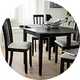An Argos Home black oval dining table with some chairs.