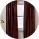 Argos Home velvet curtains placed on a window.