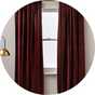 Argos Home velvet curtains placed on a window.
