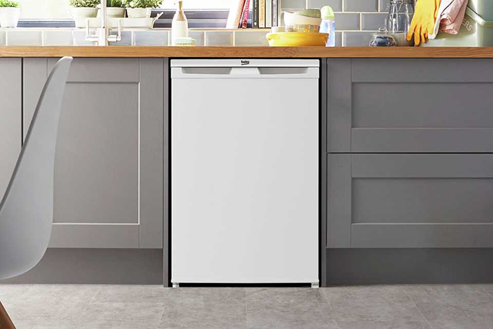 A Beko white under counter freezer in a kitchen setup.