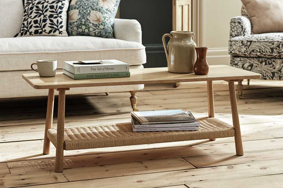 Vases, books and a cup on a Habitat x Morris & Co. Canterbury oak coffee table.
