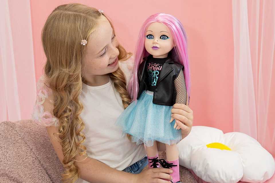 A little girl playing with DesignAfriend 18 Inch Heidi Zombie Doll.
