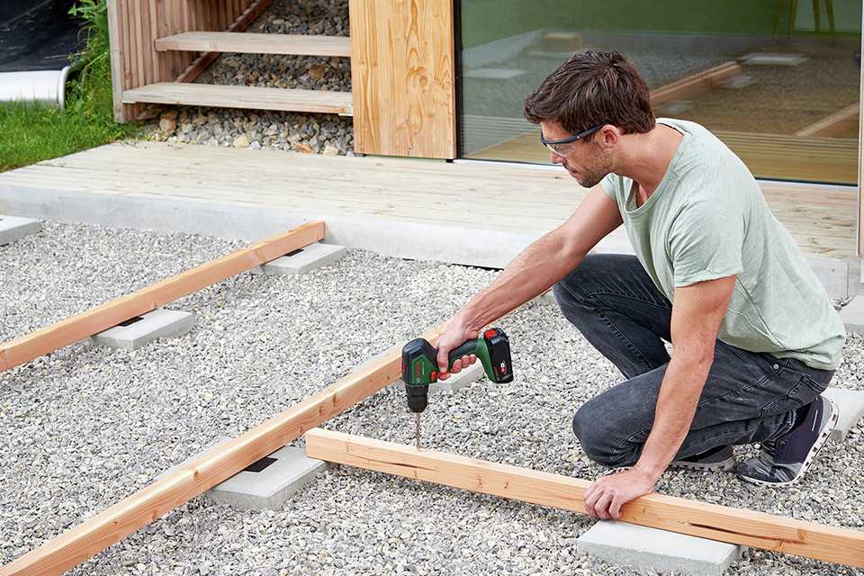 Man drilling plank of wood.