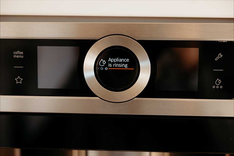 Appliance is rinsing message on a coffee machine.