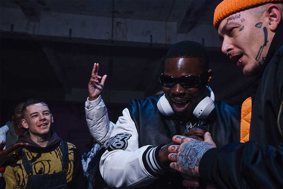 A group of friends enjoying and listening to music while wearing white Sony headphones.