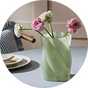A pair of green and pink Habitat Twisted Glass Vase.