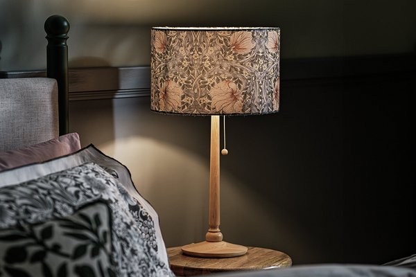 Habitat x Morris & Co. Pimpernel Printed Lampshade in blue colour placed on a bedside table.