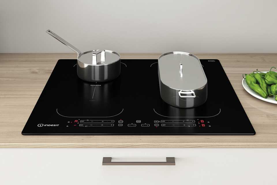 Food being cooked on a small and a large pan on Indesit IB 88B60 NE 60cm Induction Hob - Black.