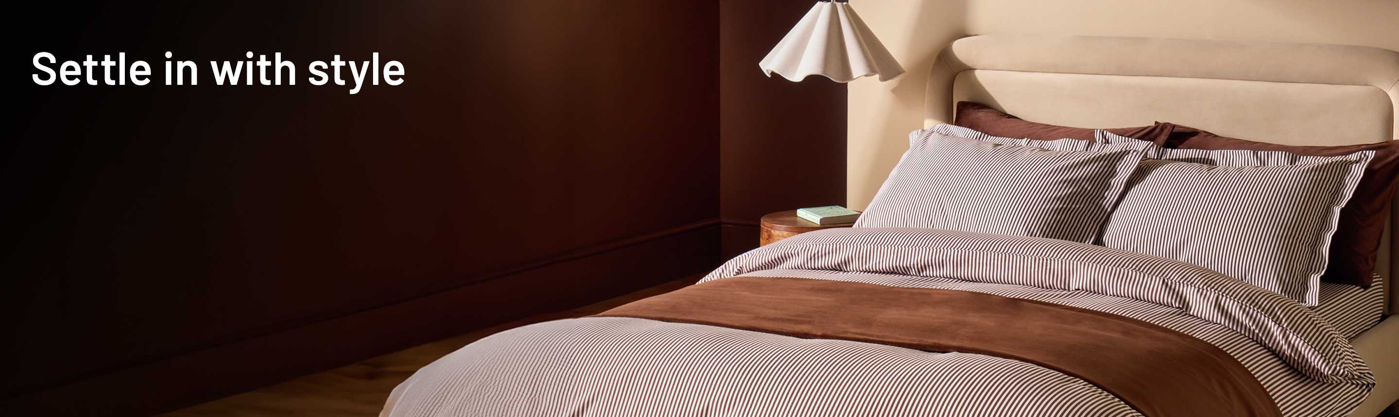 Habitat Cocoa Oxford Edge bedding displayed on a beige upholstered bed.