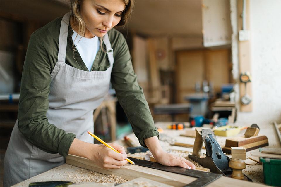Woman working on workbench.