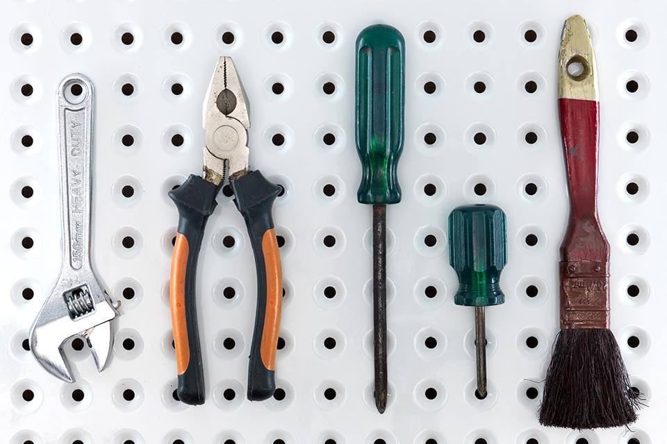 Tools hanging on a pegboard.