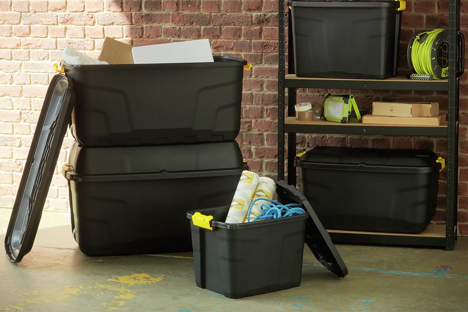Assorted storage boxes next to shelving unit.