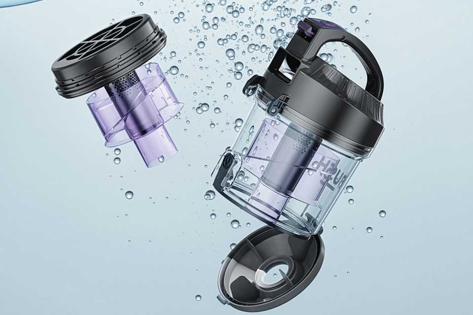 Parts of Bush Bagless Cylinder Corded Vacuum Cleaner immersed in water.