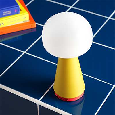 yellow table lamp with white circle shade.