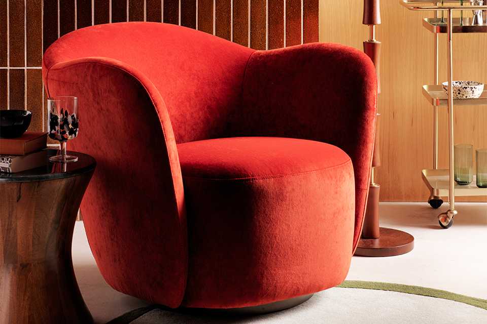 Orange velvet accent chair in home.