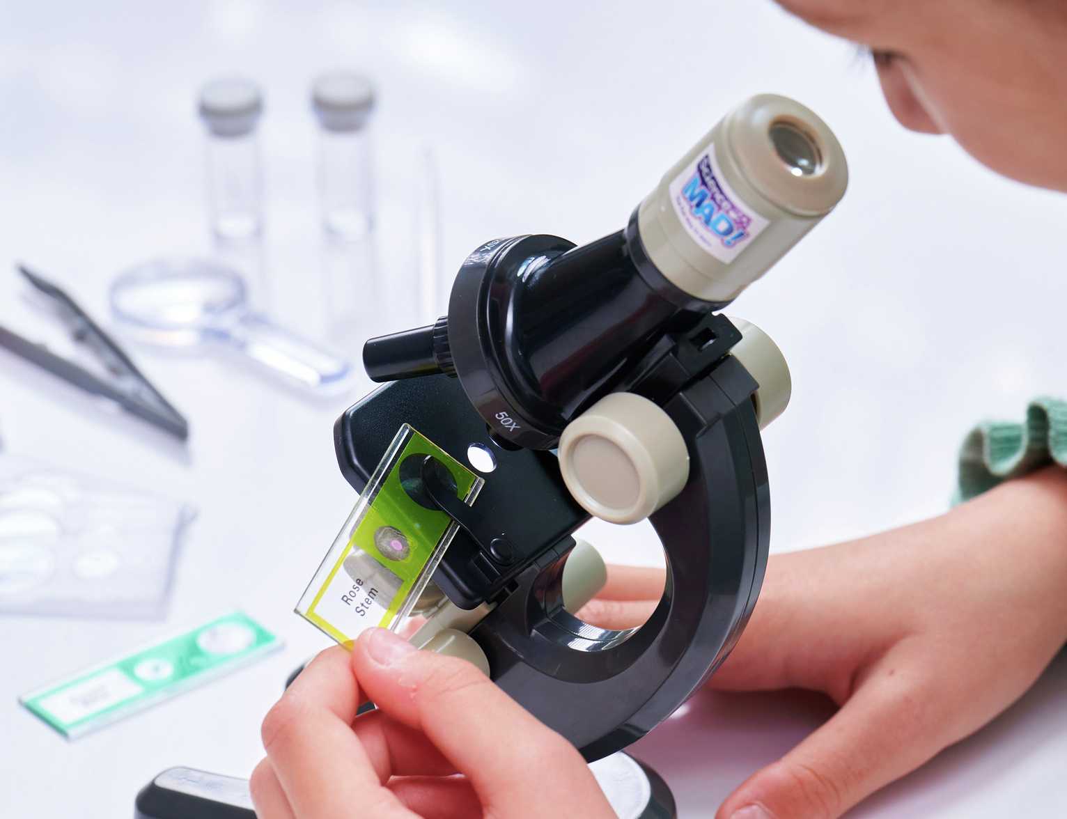 A child using a microscope.