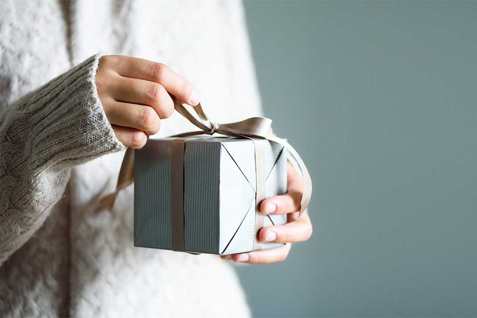 A person opening a present.
