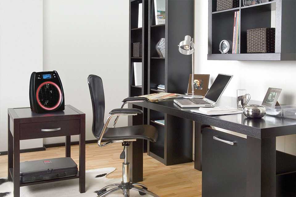 Fan heater sitting on desk in office.