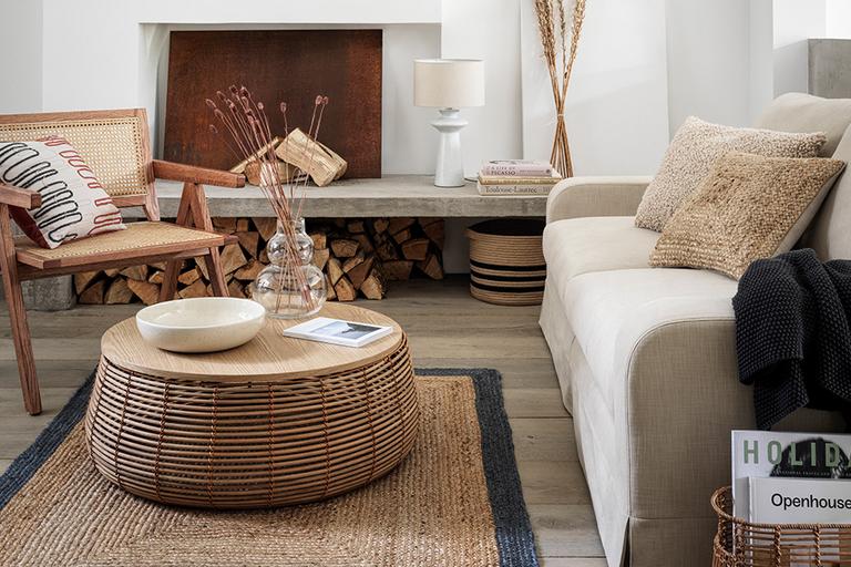 Neutral living room with cream sofa and rattan furniture.