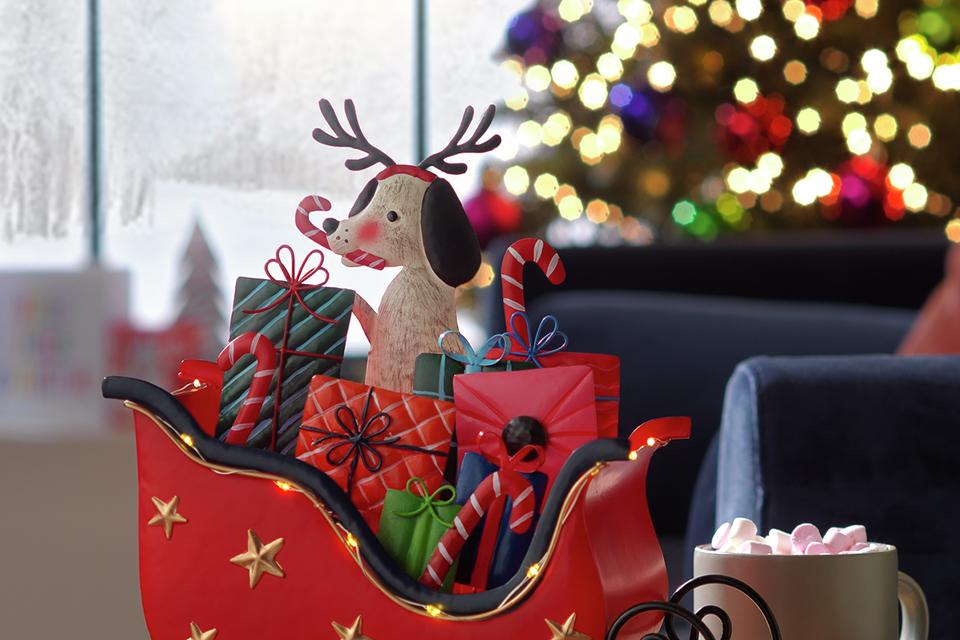 A light-up LED sleigh with presents and a cute dog with reindeer antlers.