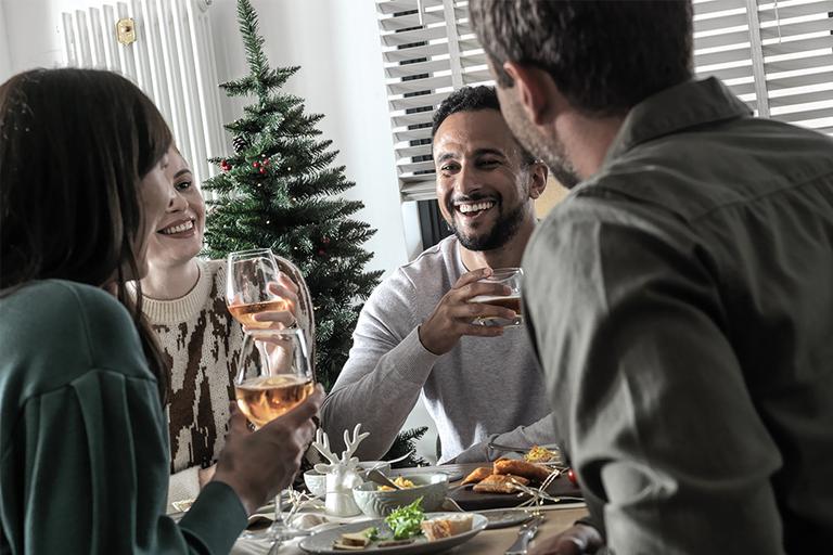Friends and family enjoying Christmas dinner together.