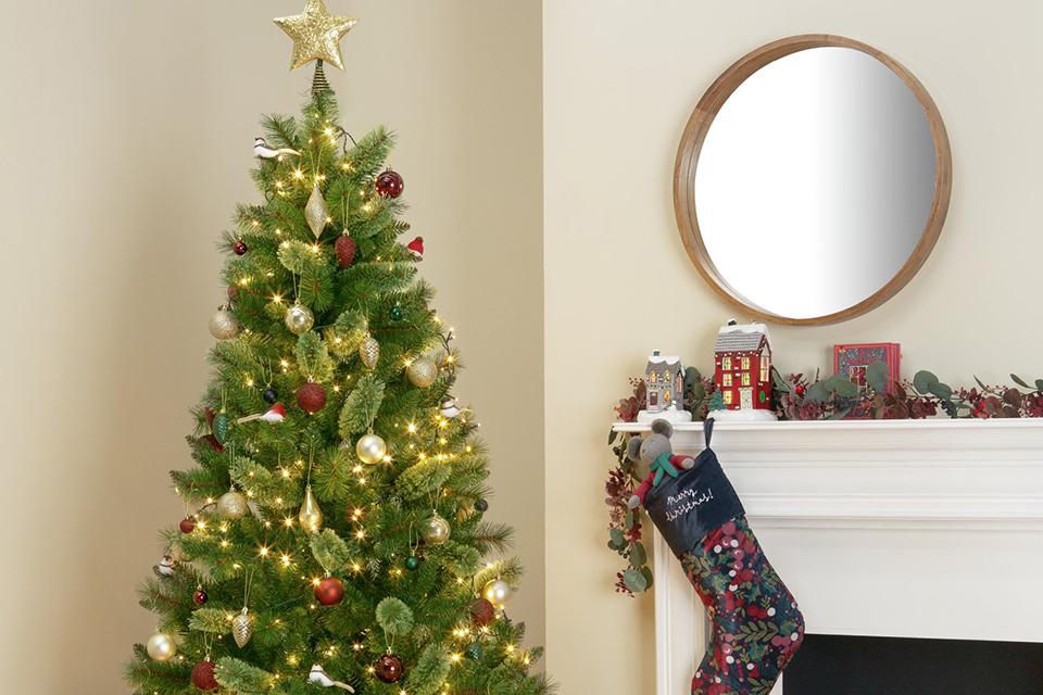 A well-decorated Christmas tree with gifts at the bottom.