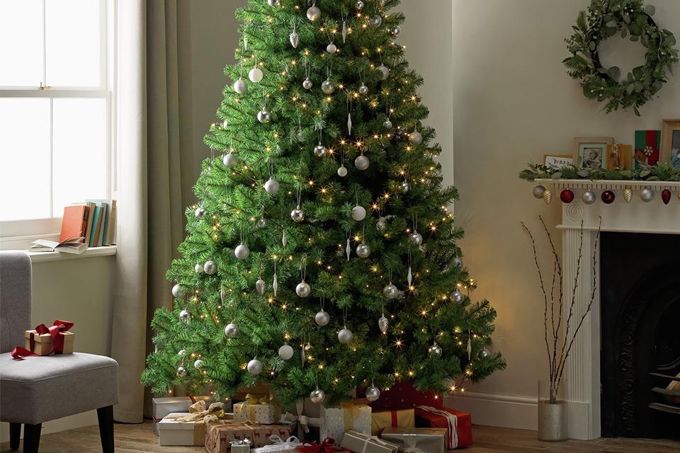 A traditional Christmas tree decorated with silver baubles.