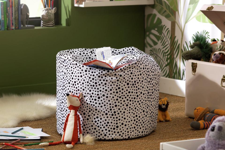 Beanbag with a polka dot pattern in a nature-themed playroom.