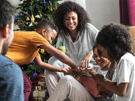 A family opening gifts together on Christmas day.