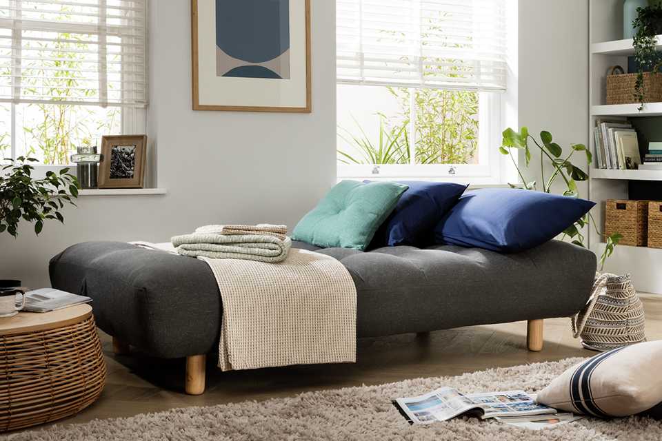 A Habitat fabric 3-seater clic clac sofa bed.