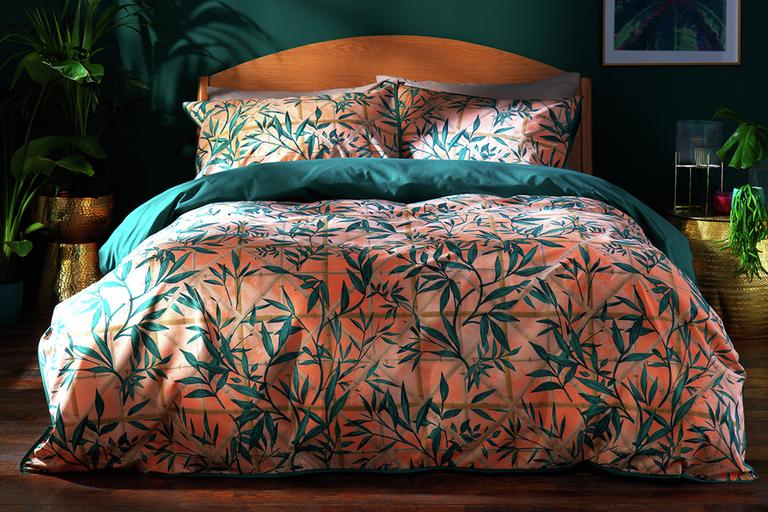 Pink bamboo print bedding in a teal bedroom.