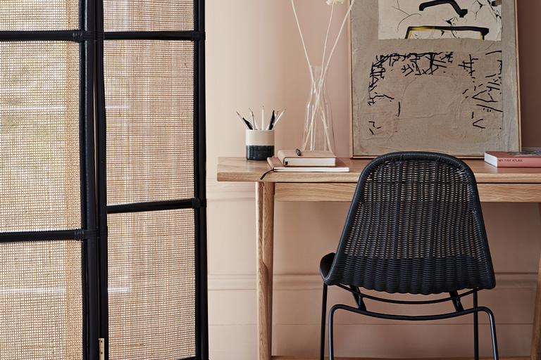 Image of a room divider next to office desk and chair.