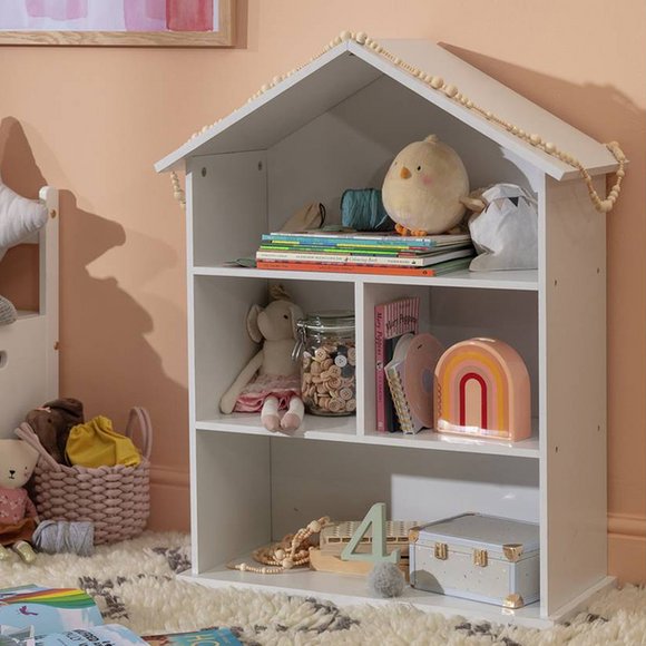 Doll house storage unit filled with books and toys.