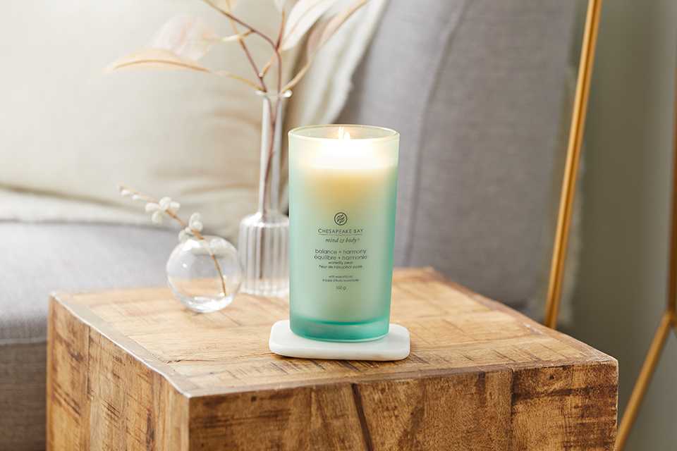 A large Chesapeake Bay Candle® kept on a bedside table.
