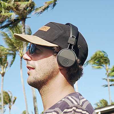 A man wearing wireless headphones on a trip.