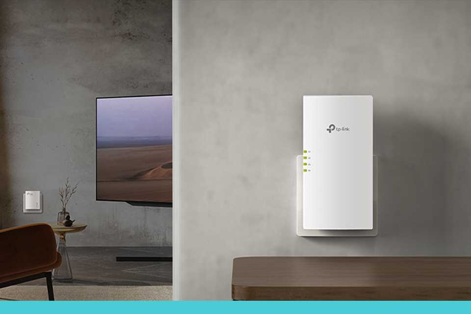 TP-Link powerline adapter kit installed on a wall in a home setup.