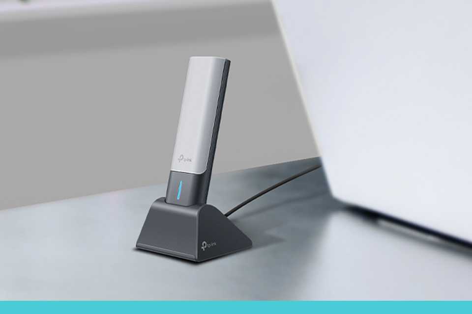 TP-Link USB Wi-Fi adapter in a living room setup.