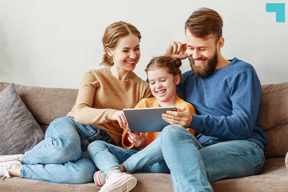 A family watching something on a tab and spending quality time together.