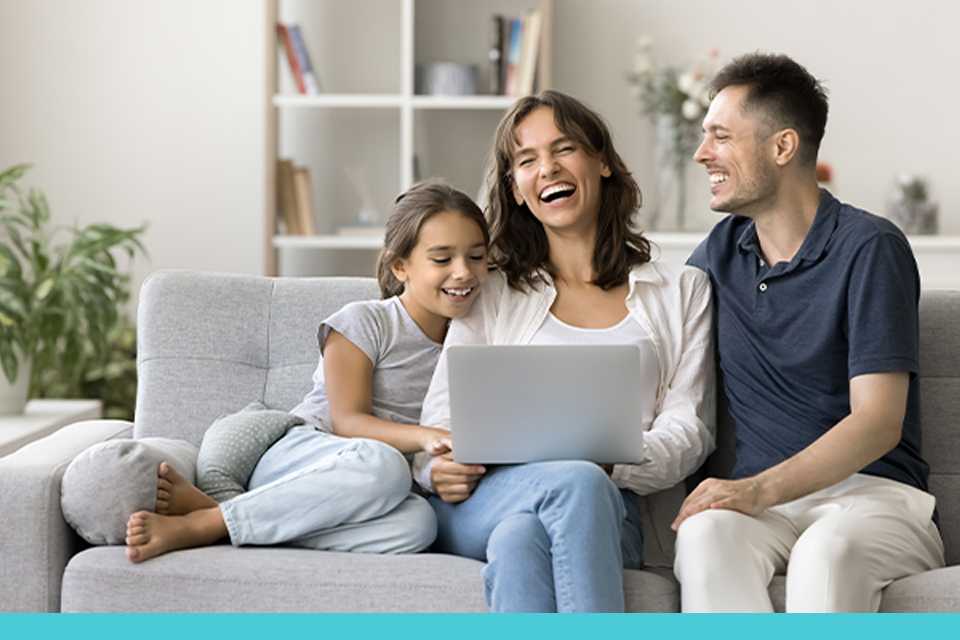 A family spending time together while watching something on laptop connected via TP-Link Wi-Fi.